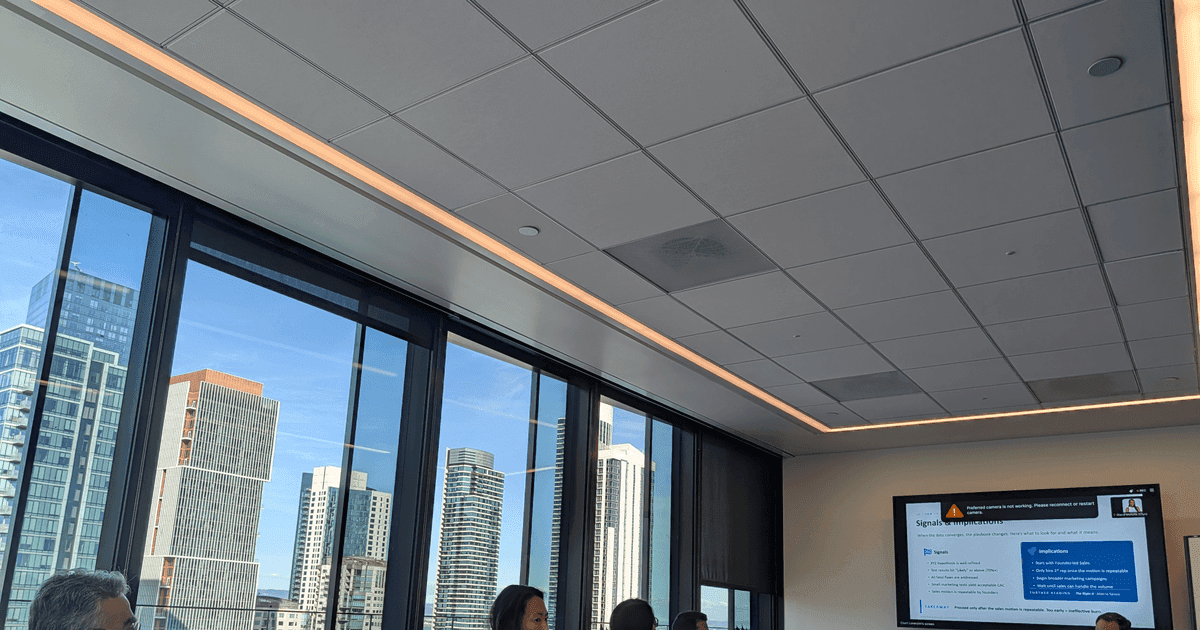 FounderNexus members in a boardroom session with a presentation on screen